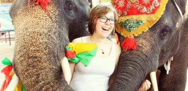 Traveller enjoying a close encounter with decorated elephants during an adventure experience