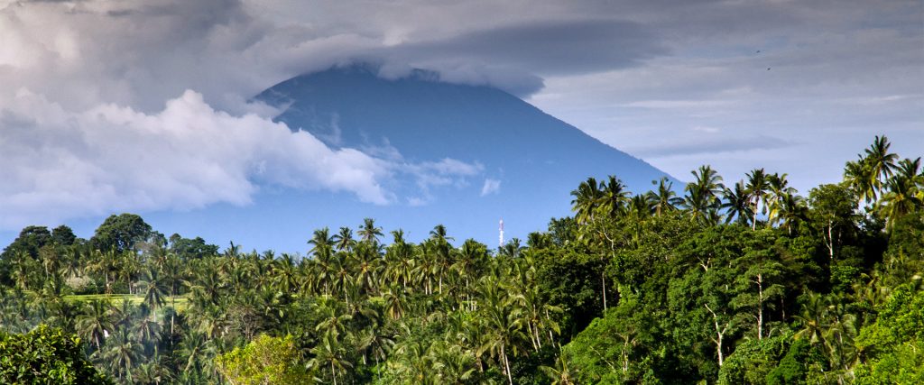 Lush tropical forest with a cloud-covered volcano in Costa Rica