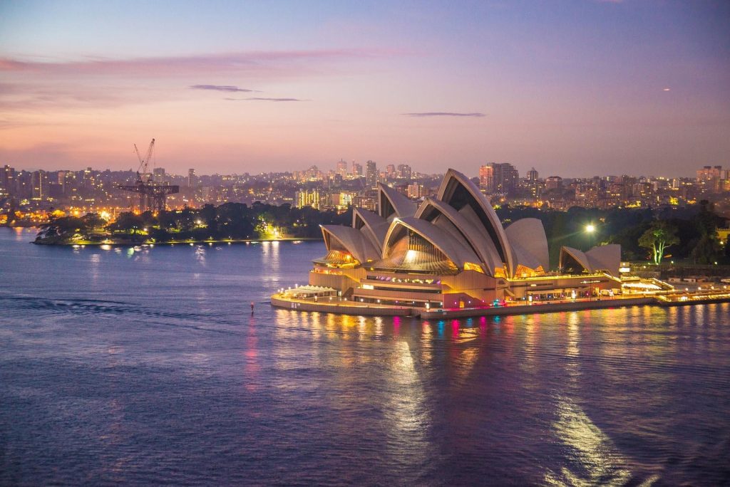 Sydney Opera House illuminated at dusk overlooking Sydney Harbour, Australia
