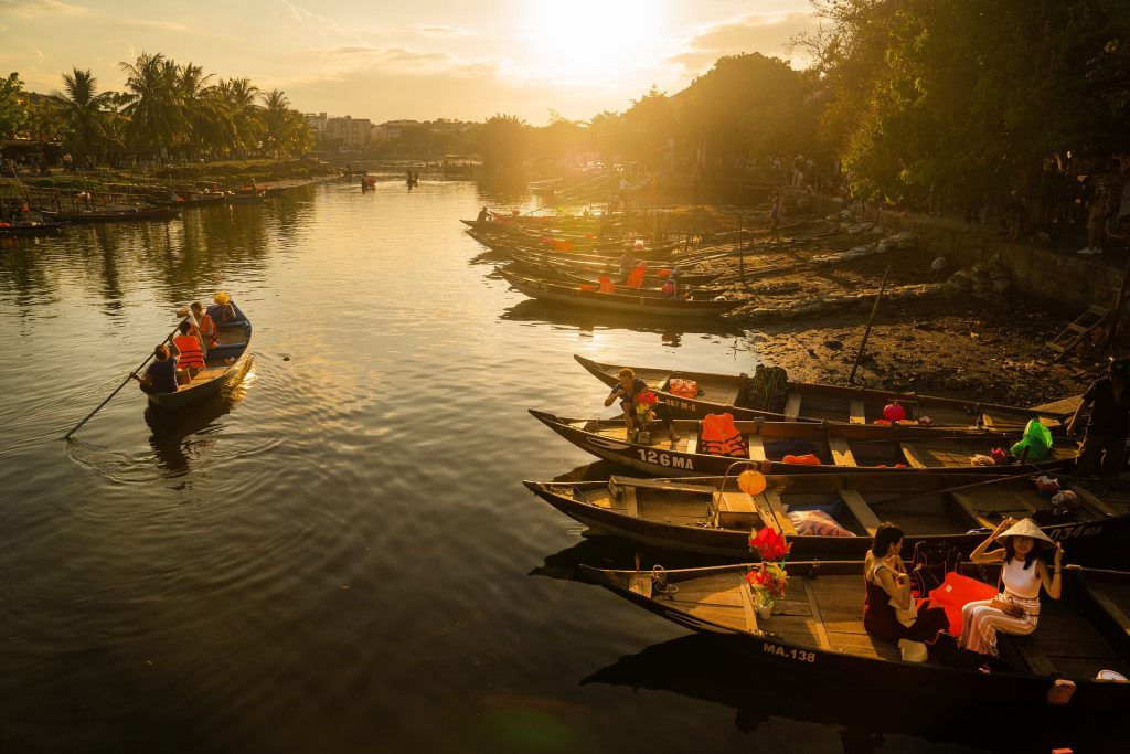 Traditional wooden boats on a calm river at sunset