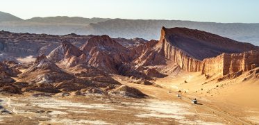 Dramatic desert rock formations overlooking a vast arid valley